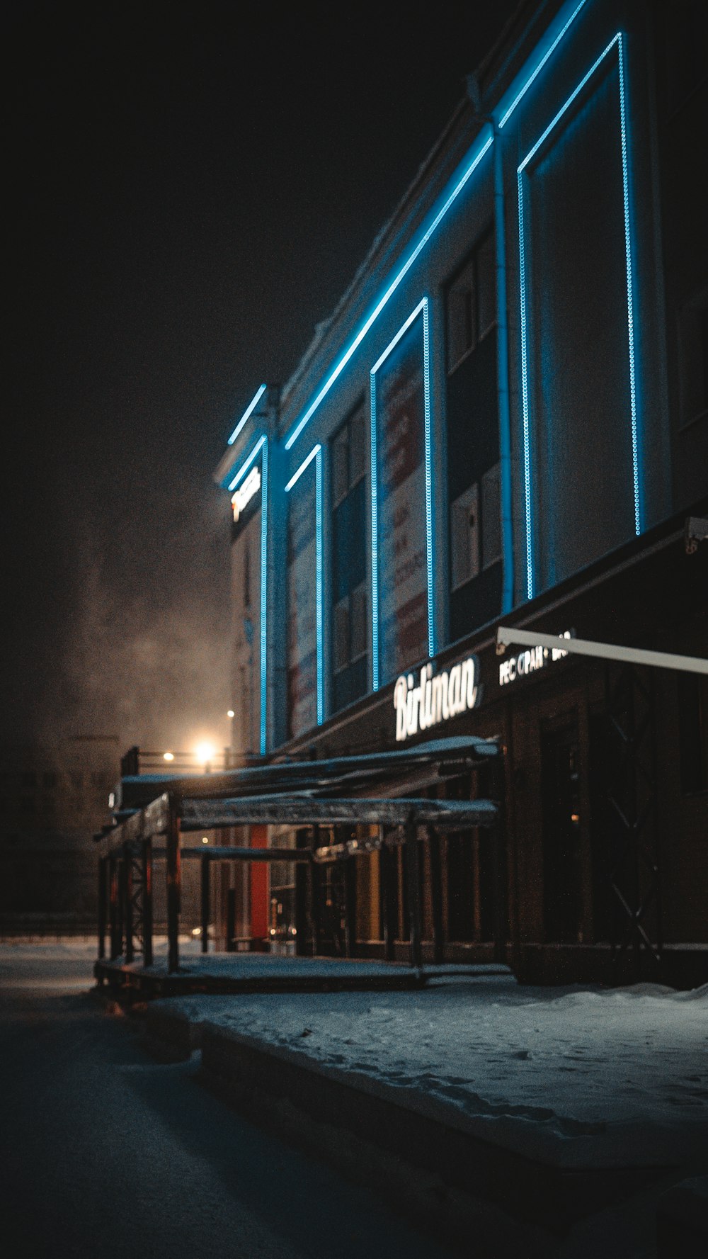 a building with a neon sign on the side of it