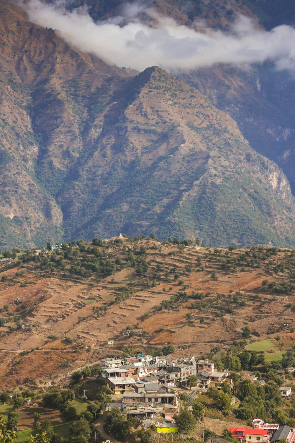 a view of a mountain range with houses in the foreground