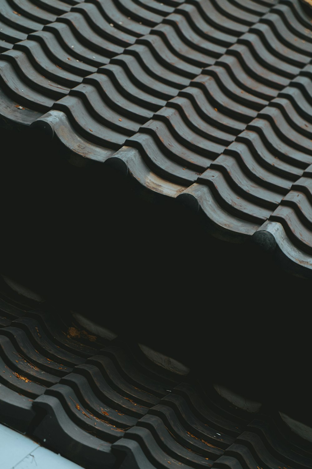 a close up of a roof with wavy tiles