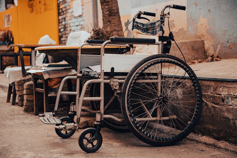 a wheel chair sitting on the side of a road