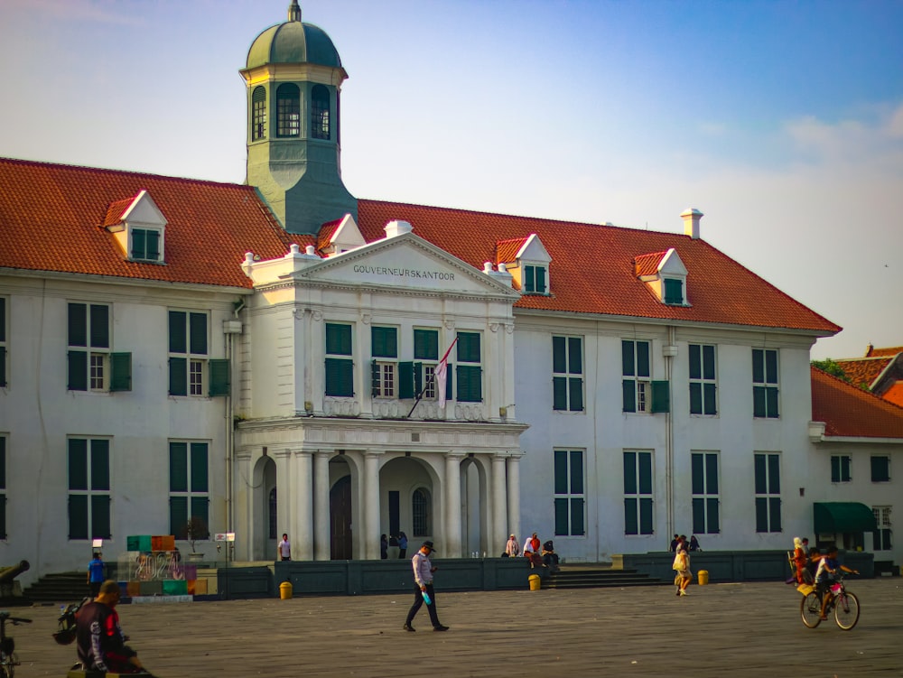 a large white building with a red roof