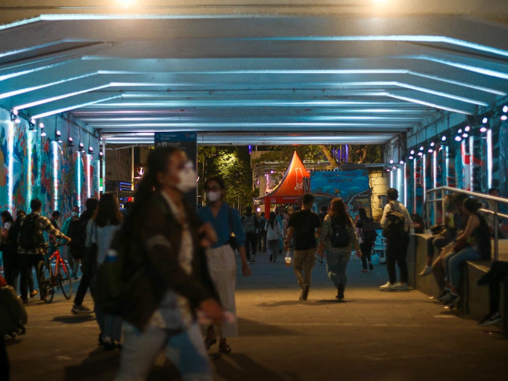 a group of people walking under a covered walkway