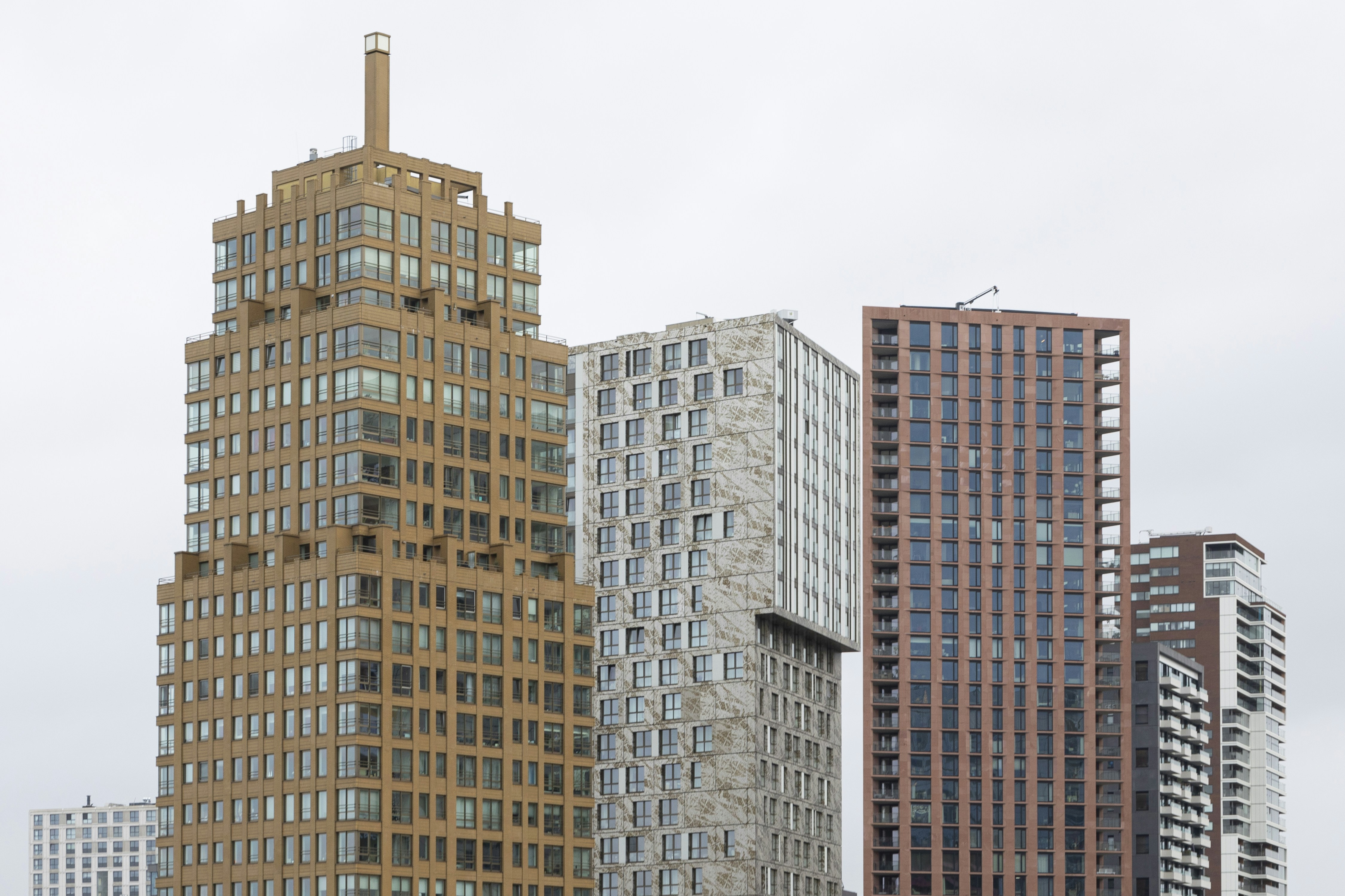 A group of tall buildings sitting next to each other photo – Free ...