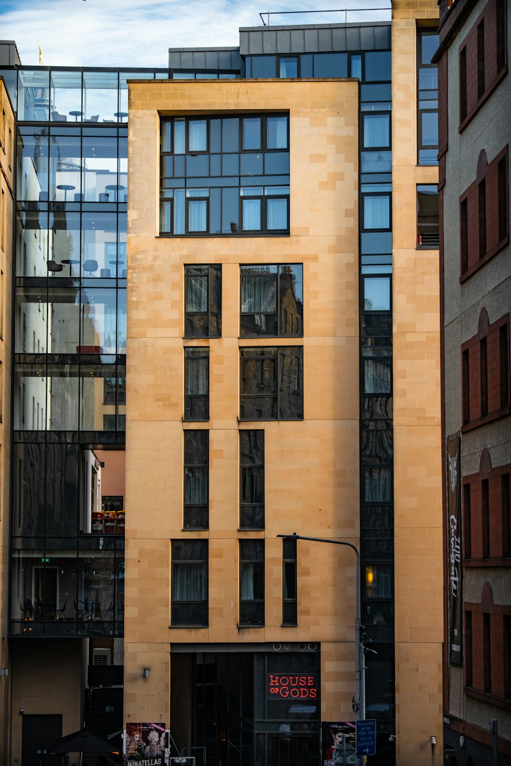 a tall building with lots of windows next to a street