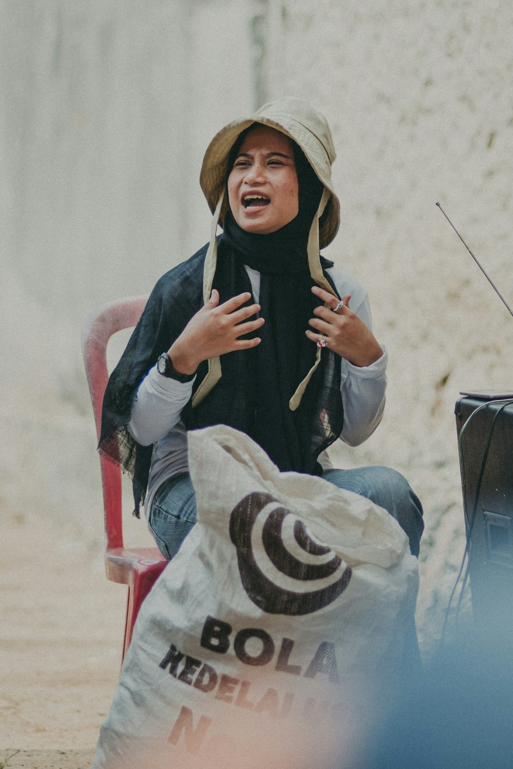 a woman sitting in a chair talking to someone