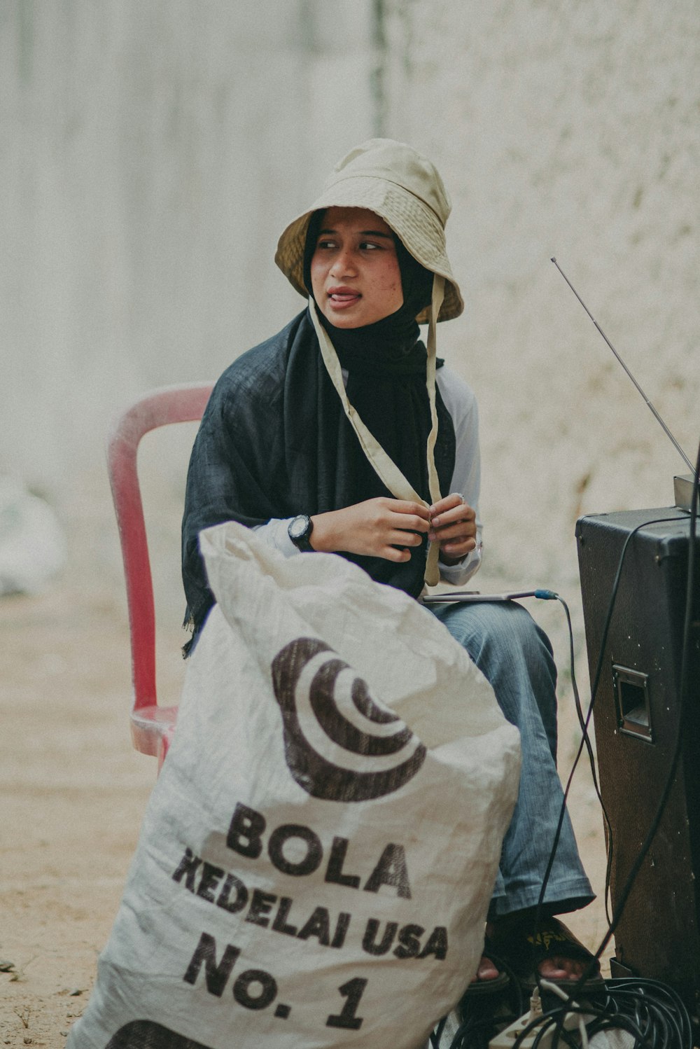 a person sitting on a chair with a bag