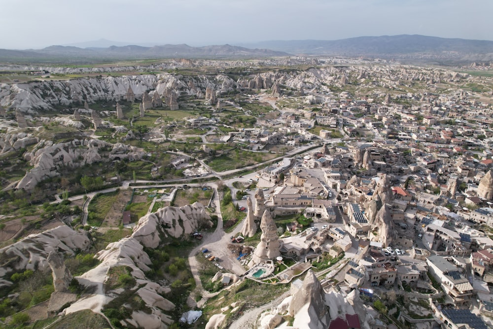 a bird's eye view of a city with mountains in the background