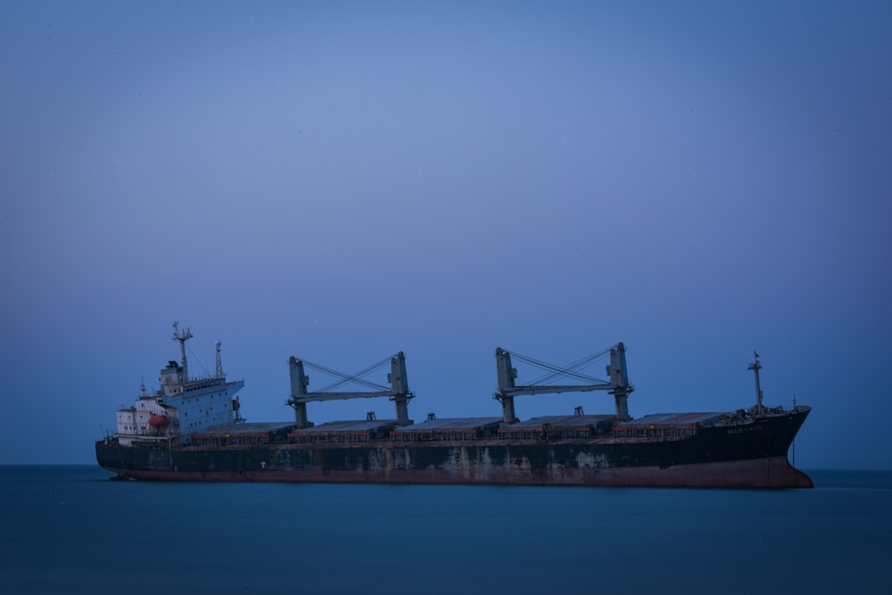 a large cargo ship sitting in the middle of the ocean