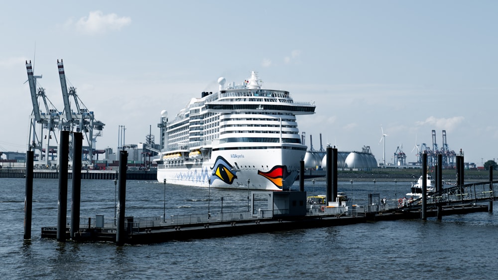 a large cruise ship docked at a pier