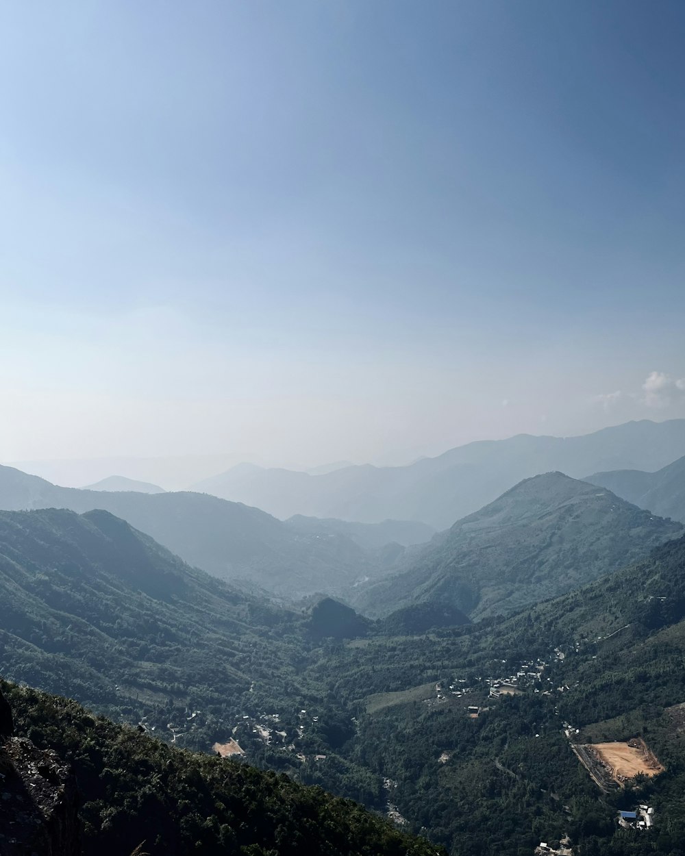 a view of a valley with mountains in the background