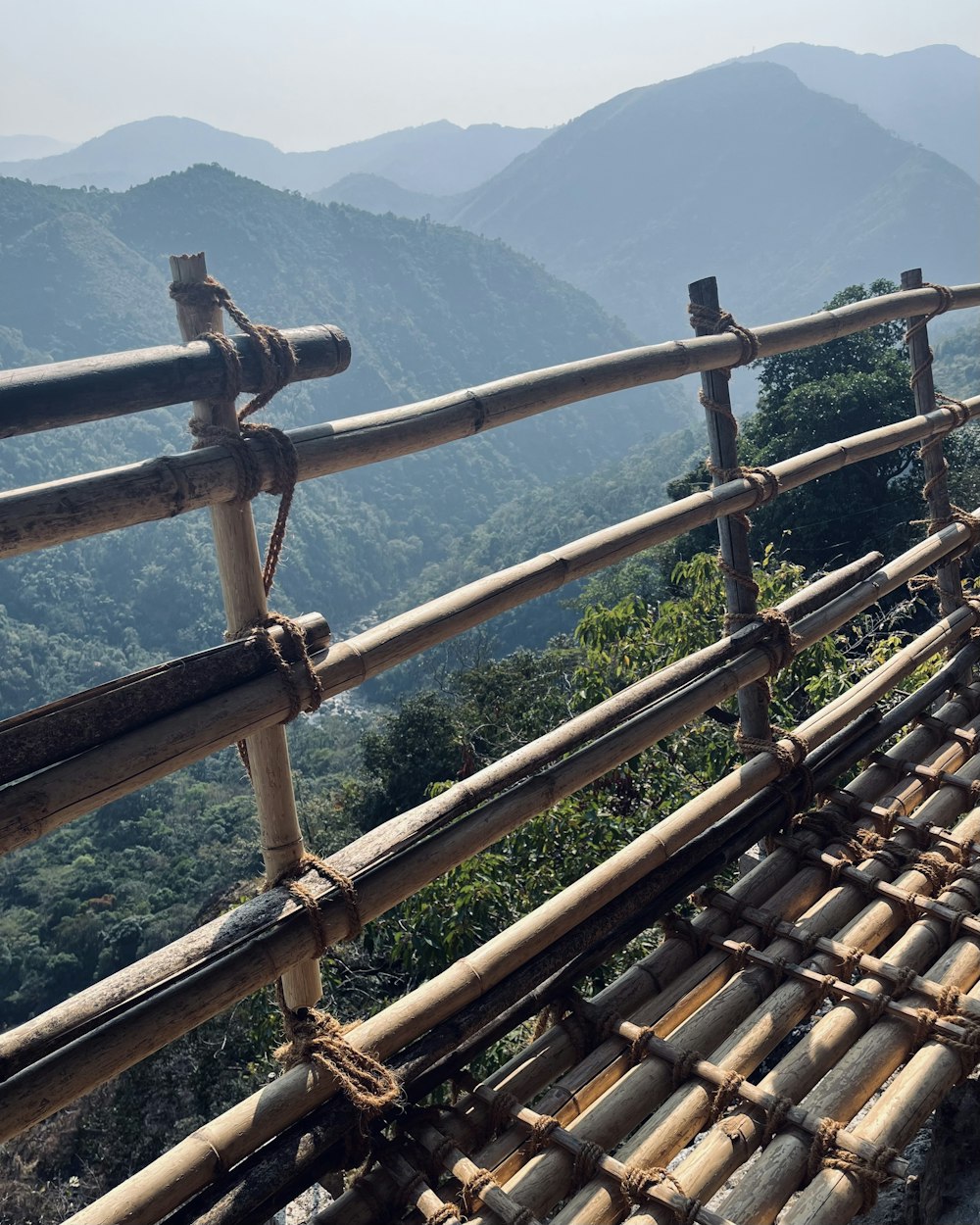 a bamboo hammock with mountains in the background