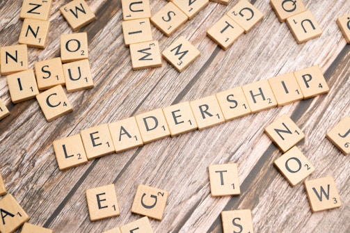 scrabble tiles spelling out the word leadership on a wooden surface