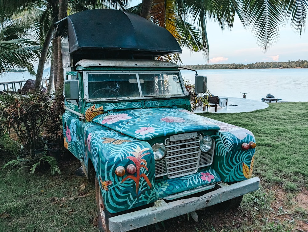 an old truck painted with a tropical theme