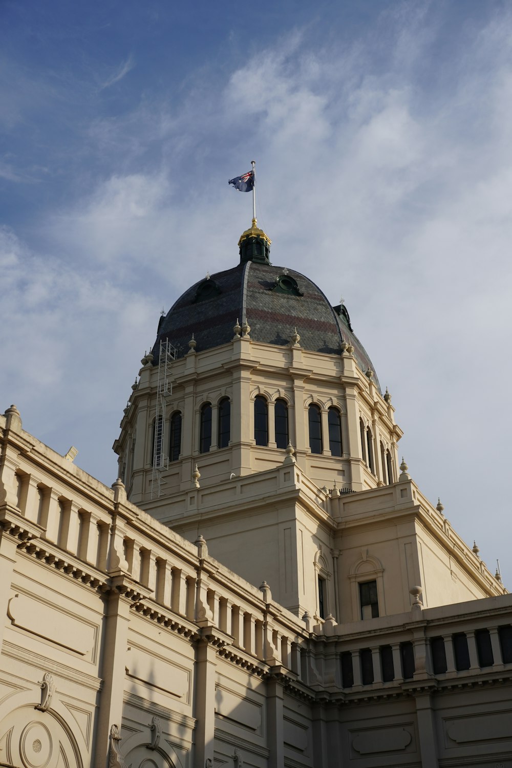 a large building with a dome and a flag on top