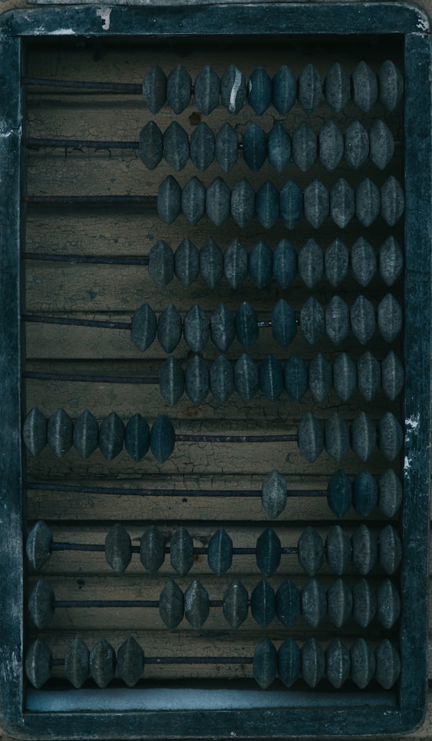 a wooden box filled with lots of black knobs