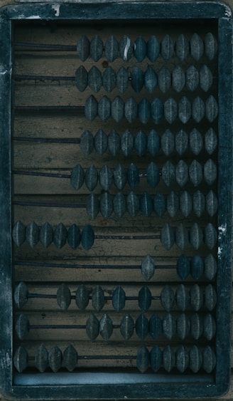 a wooden box filled with lots of black knobs