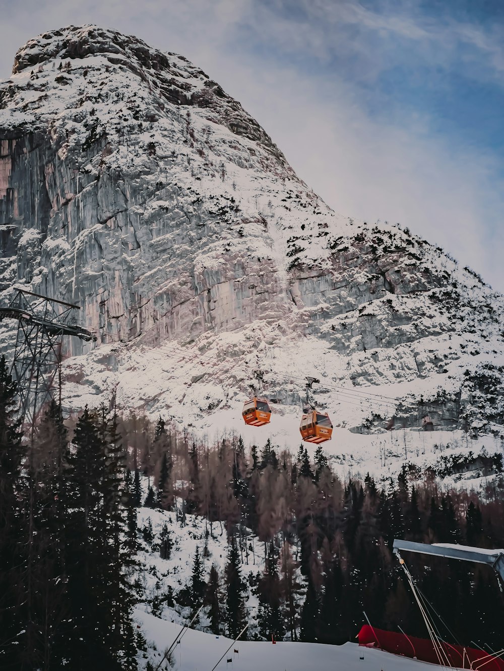 a ski lift going up the side of a mountain