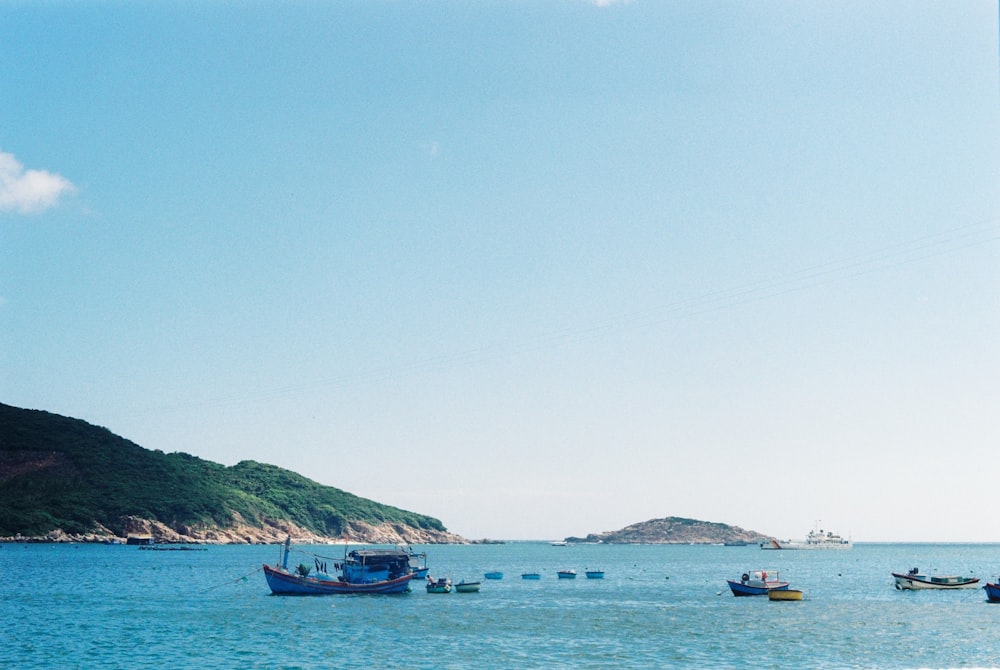 a group of boats floating on top of a large body of water