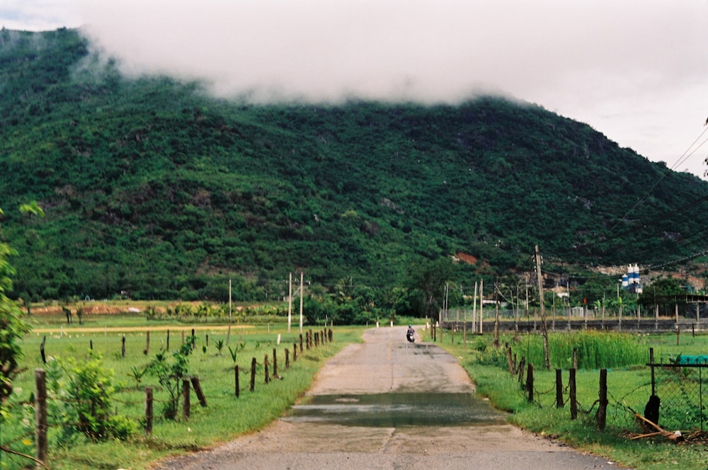 a person riding a motorcycle down a dirt road