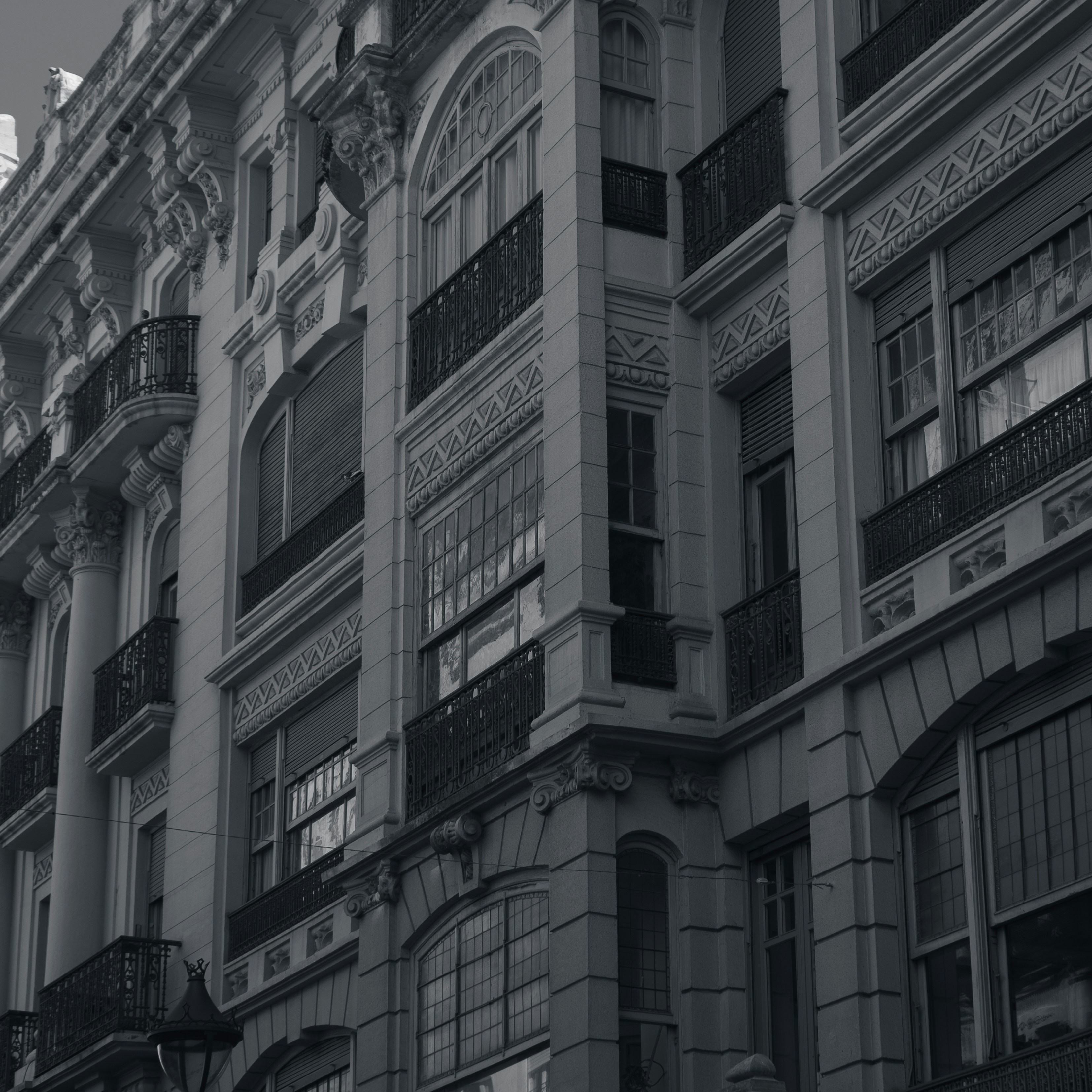 a black and white photo of a building with balconies