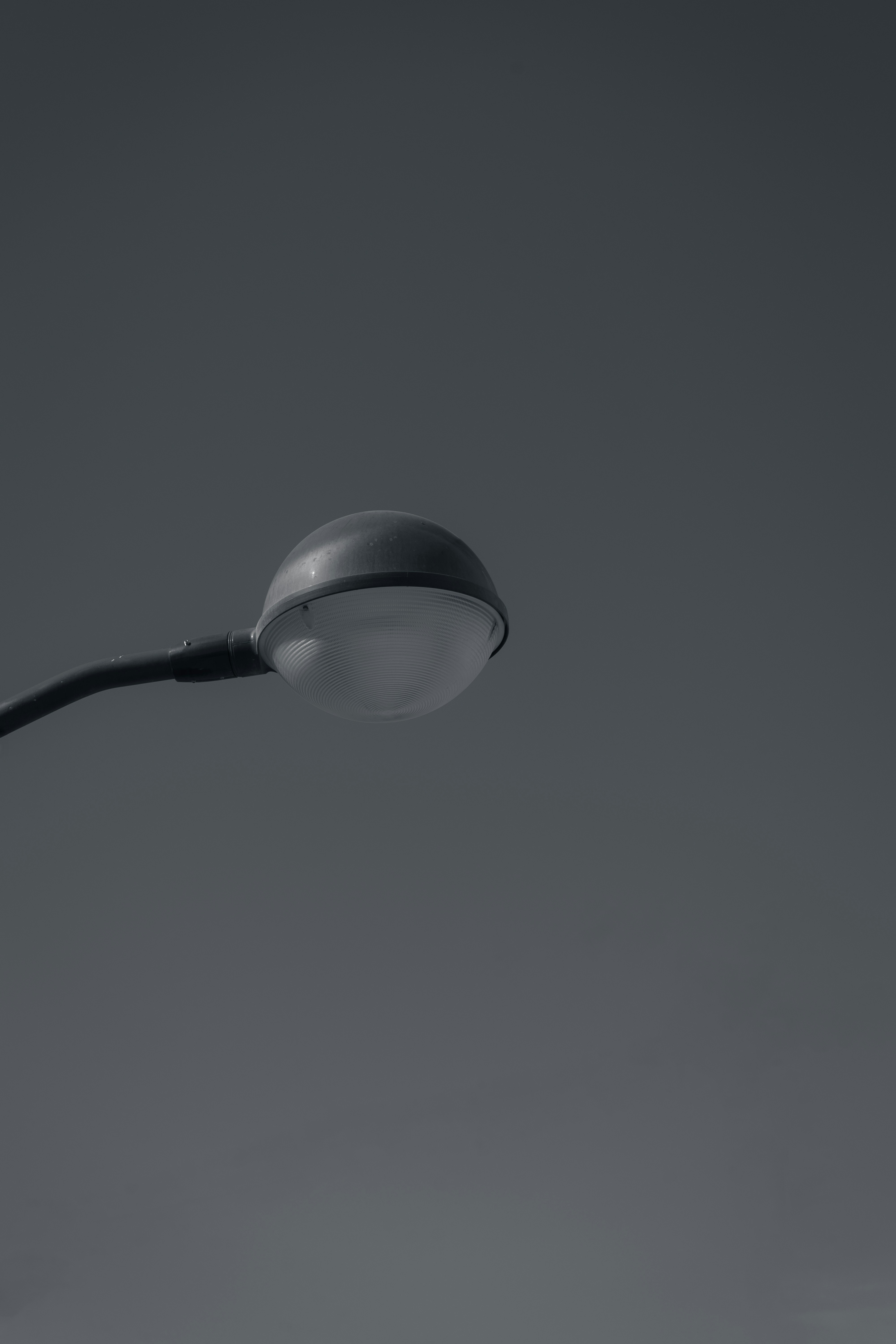 a black and white photo of a street light