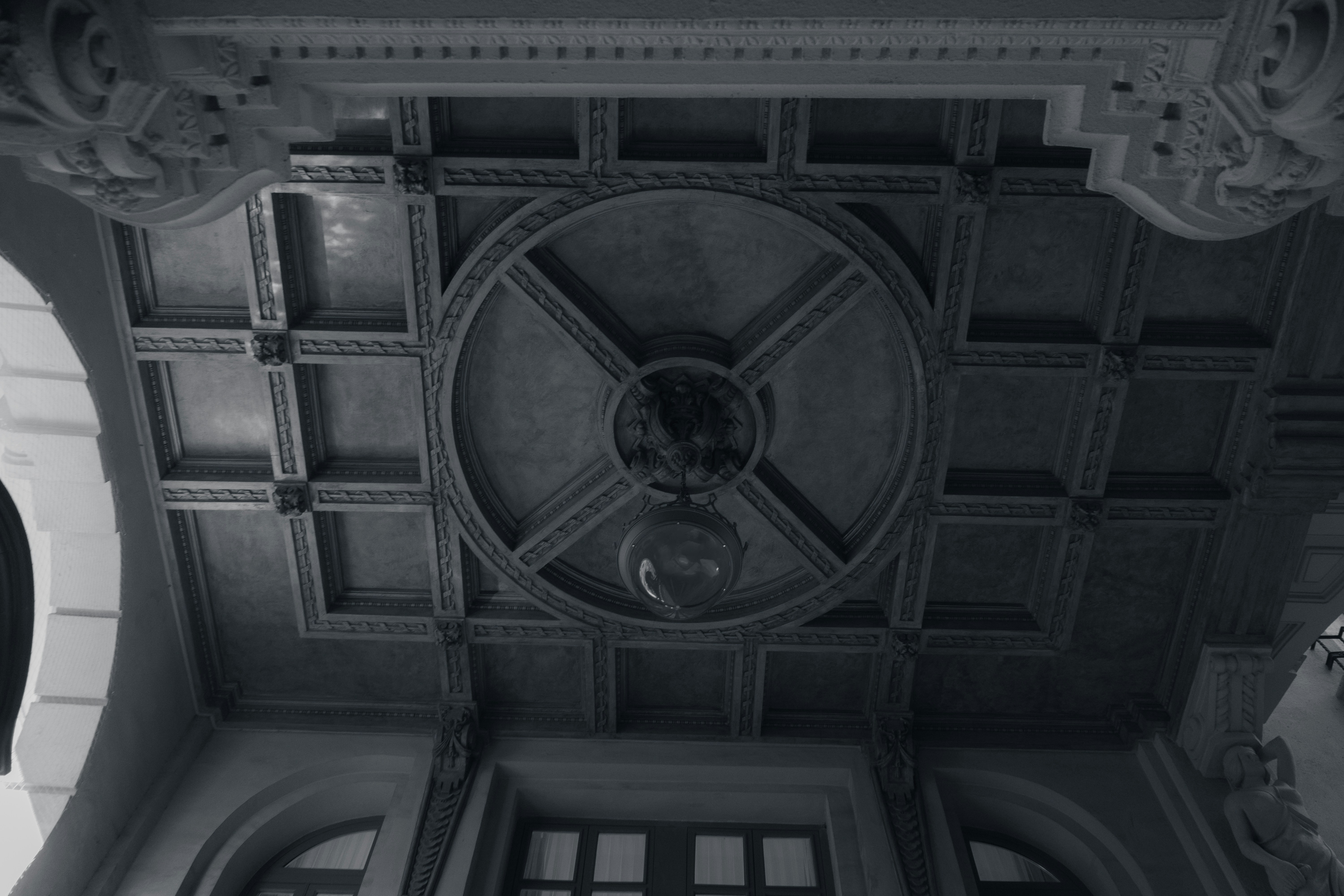 a black and white photo of a ceiling in a building