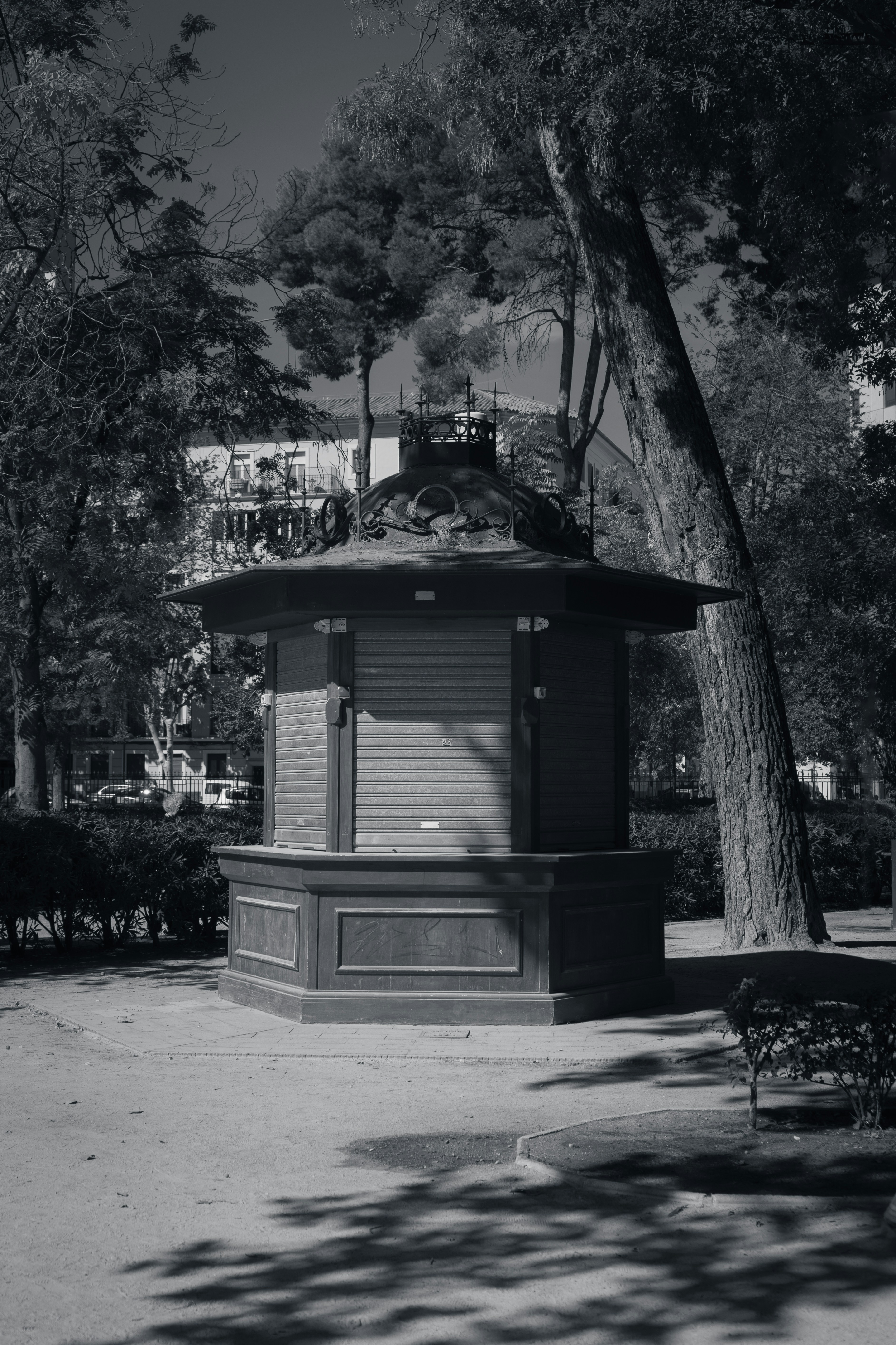 a black and white photo of a bench in a park