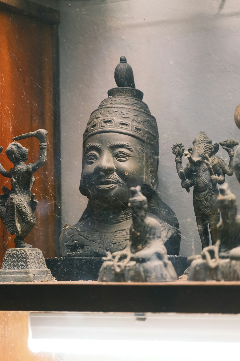 a group of statues sitting on top of a shelf