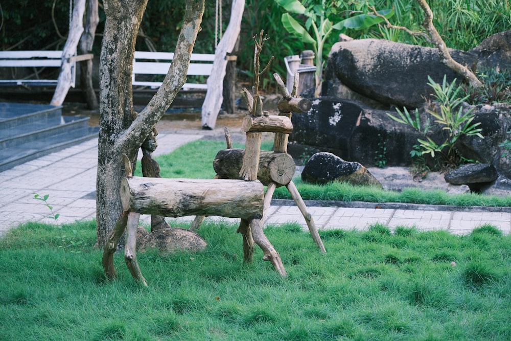 a wooden bench sitting on top of a lush green field