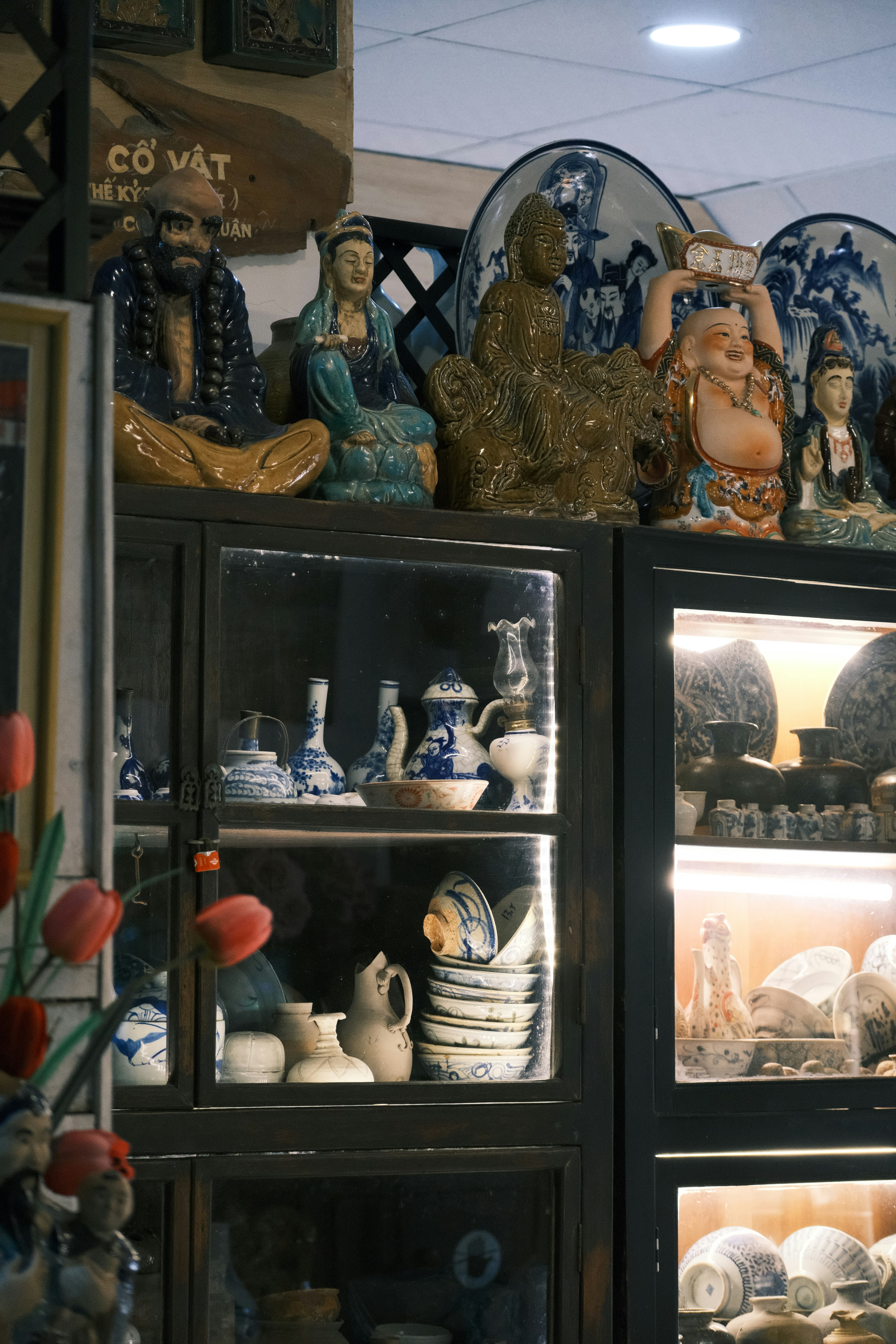 a display case filled with lots of vases and figurines