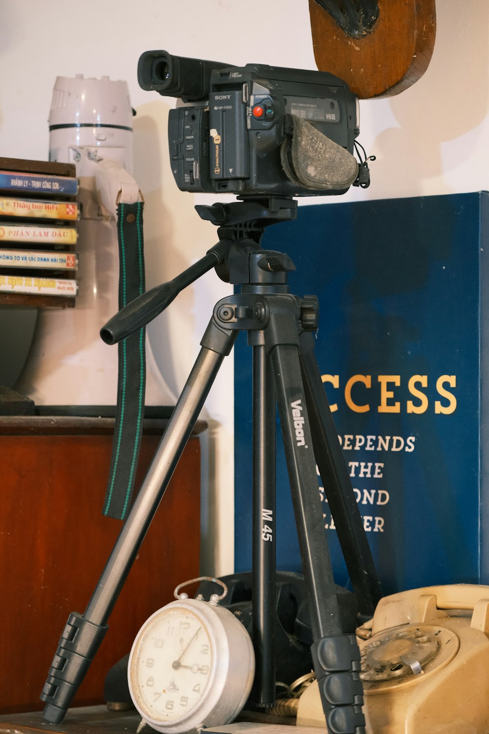 a camera on a tripod in front of a book