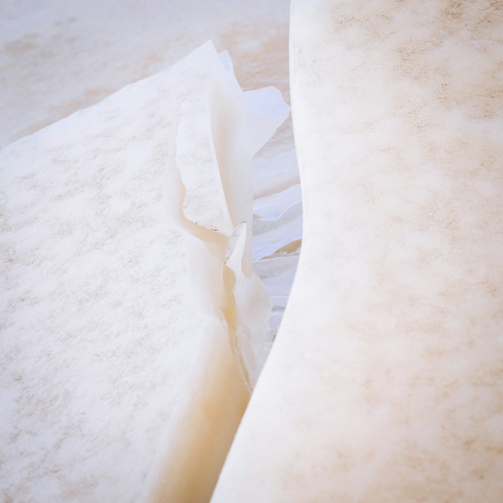 a close up of two mattresses with sheets on them
