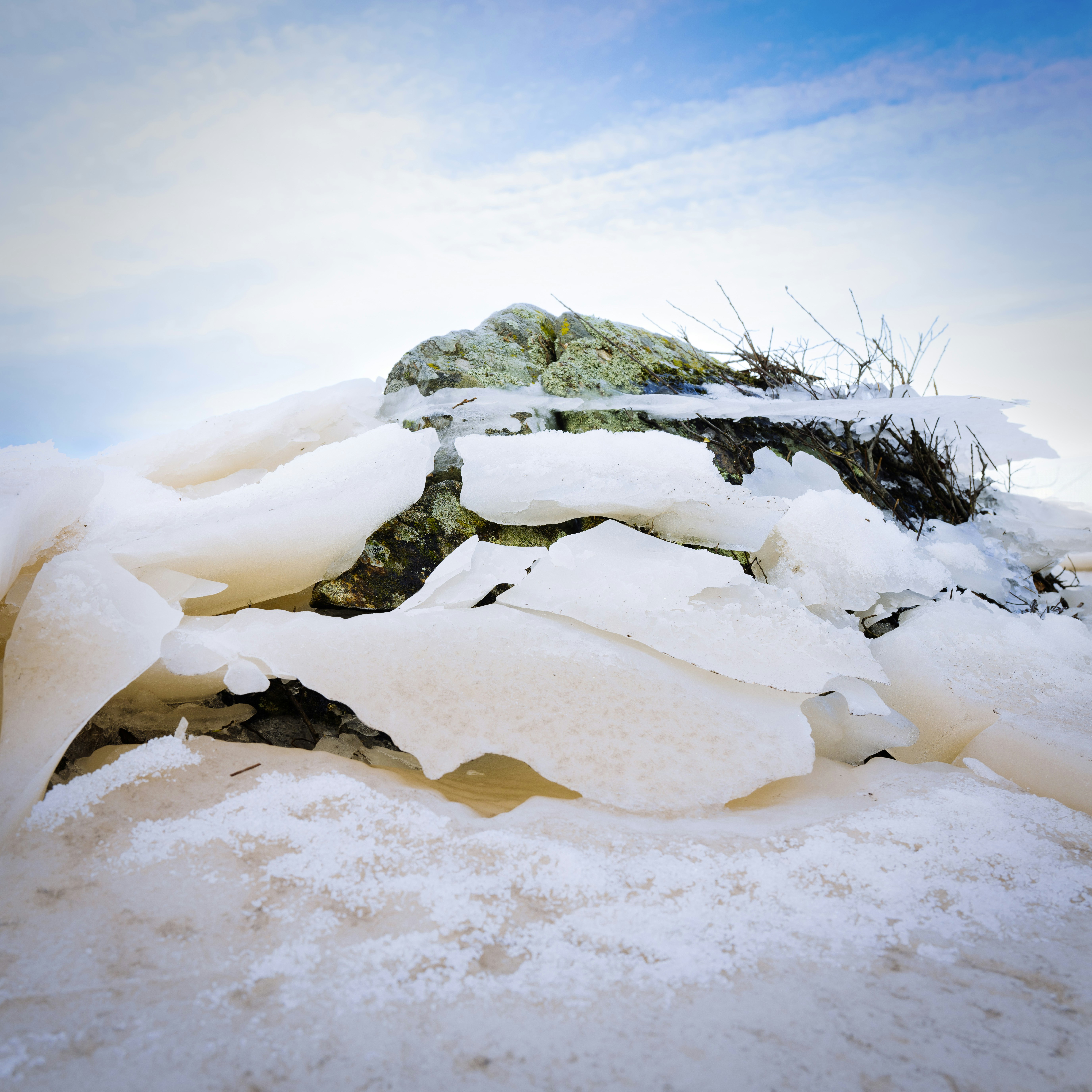 a pile of snow sitting on top of a snow covered ground