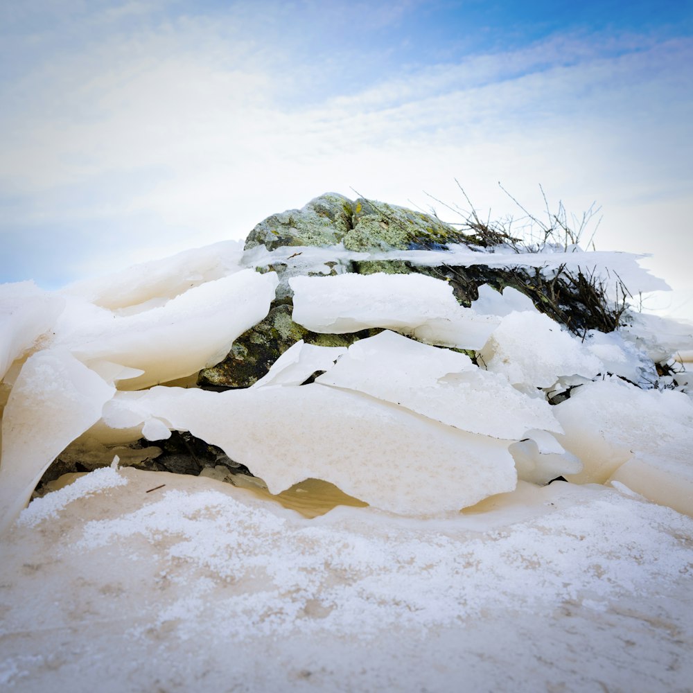 a pile of snow sitting on top of a snow covered ground