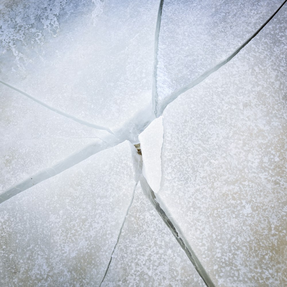 a broken umbrella sitting on top of a snow covered ground