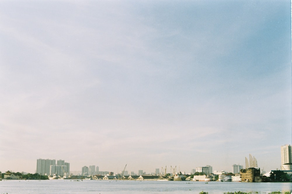 a large body of water with a city in the background