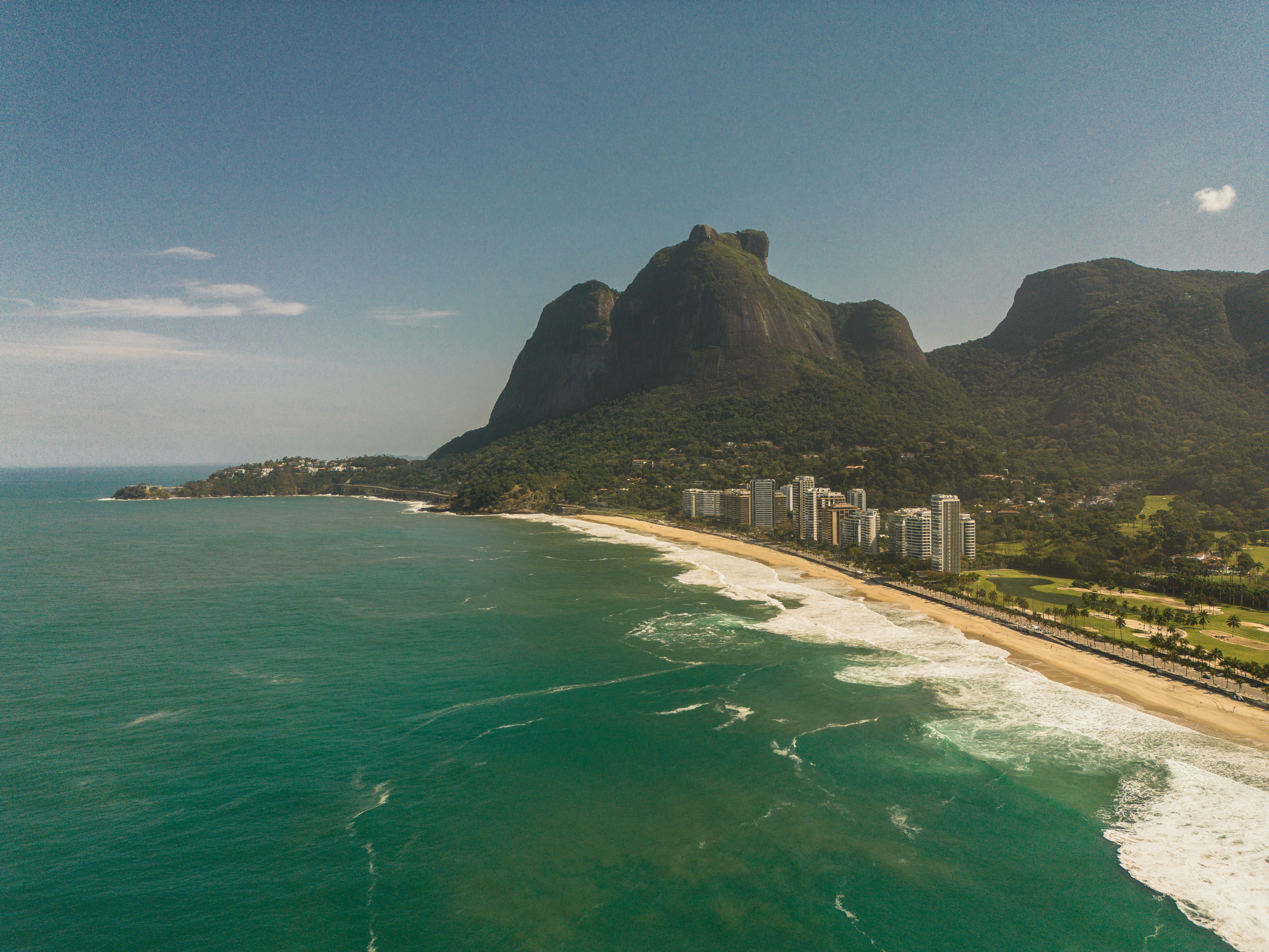 an aerial view of a beach with a city in the background