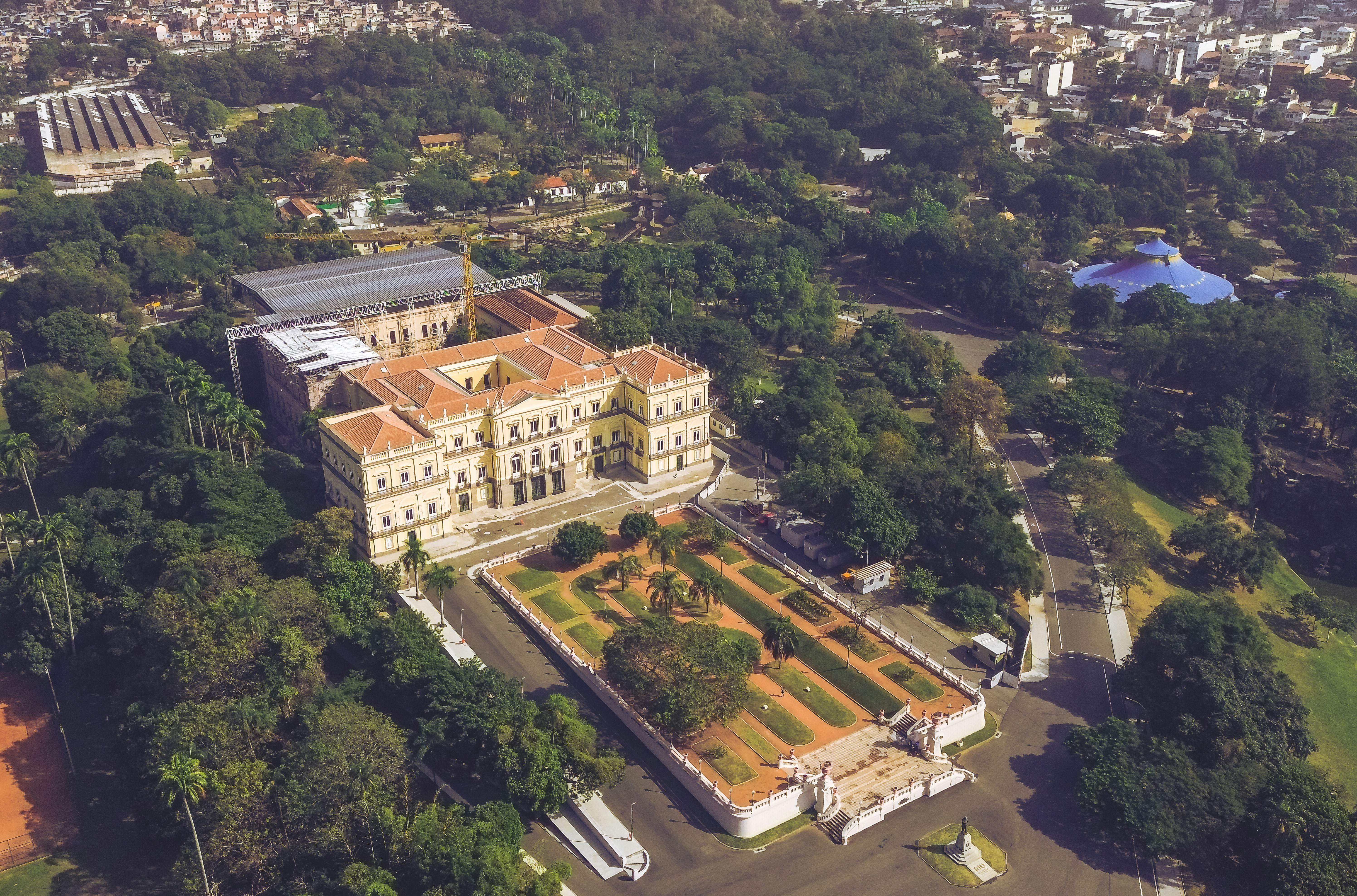 an aerial view of a large building surrounded by trees