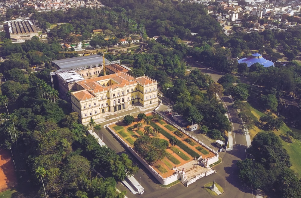 an aerial view of a large building surrounded by trees