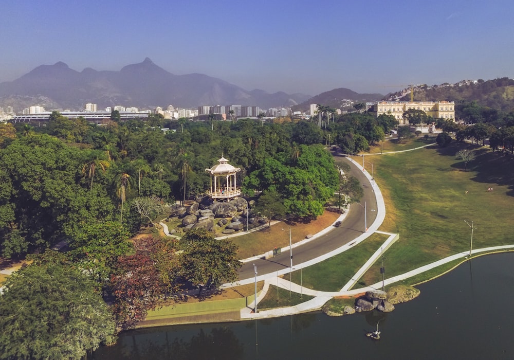 an aerial view of a park with mountains in the background