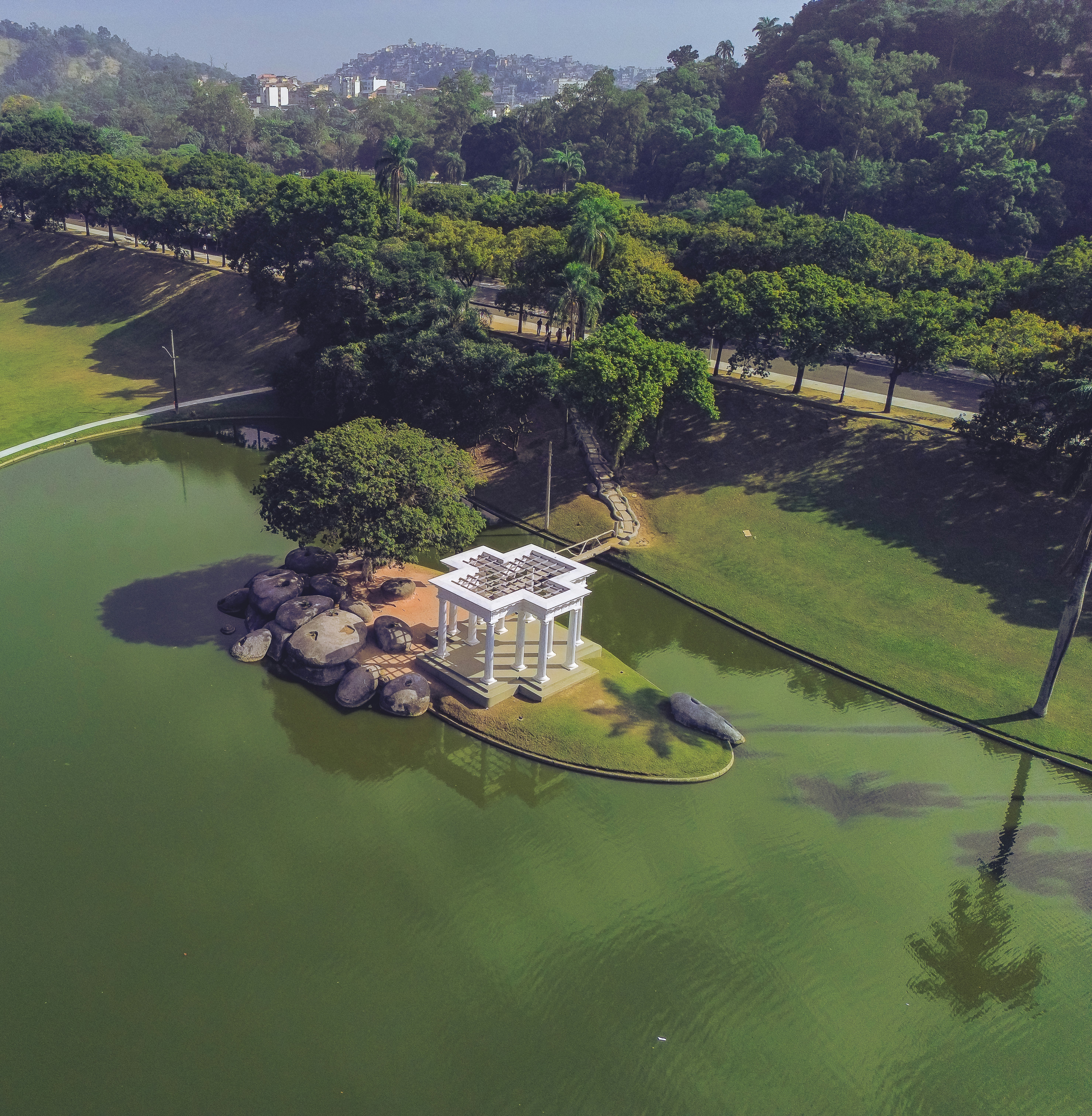 an aerial view of a small white structure in the middle of a lake
