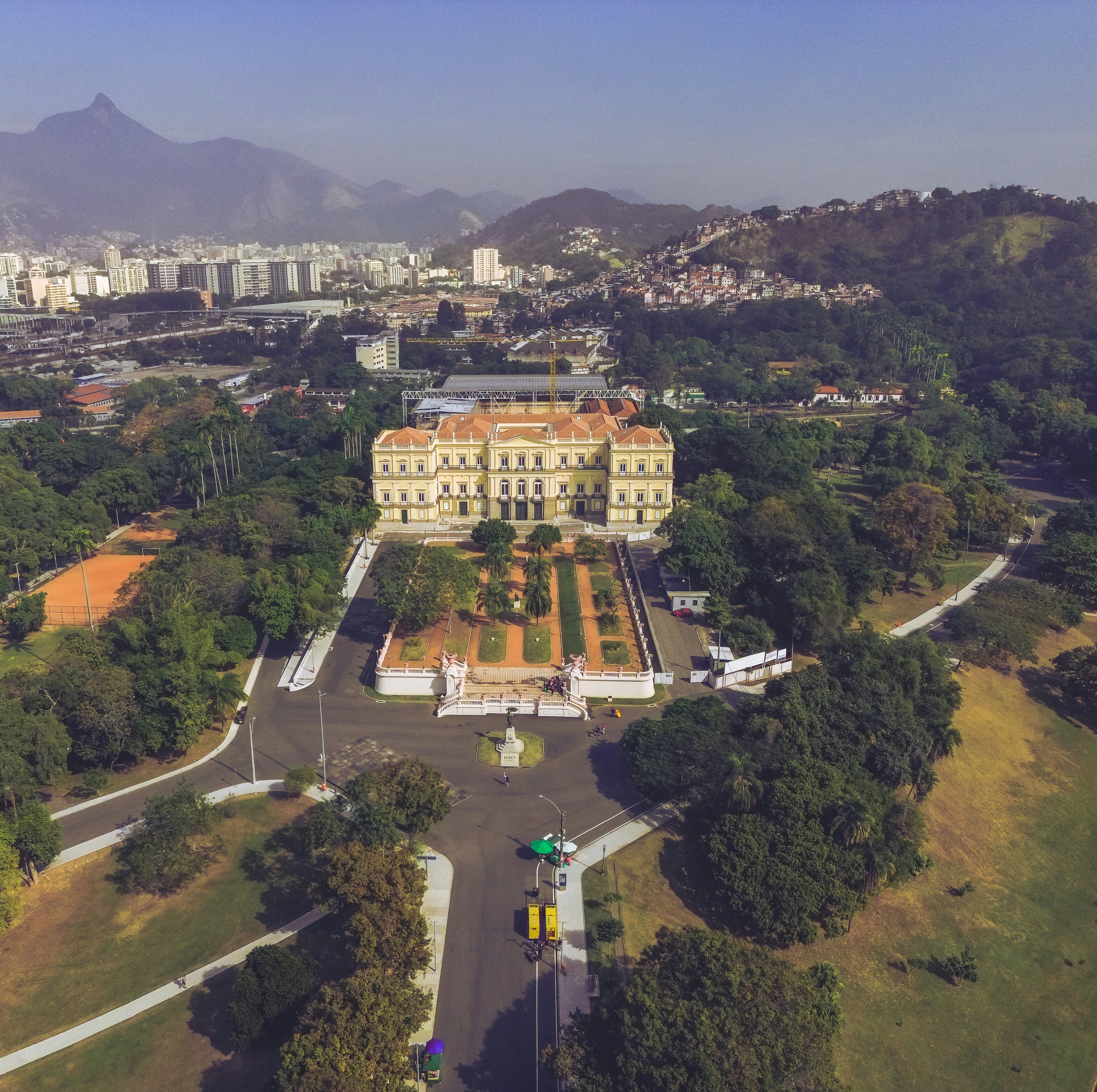 an aerial view of a large building surrounded by trees