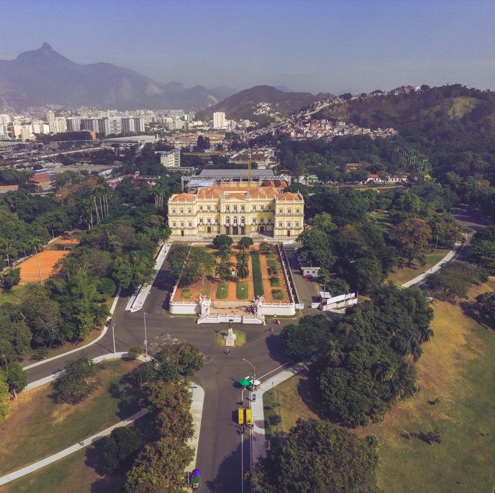 an aerial view of a large building surrounded by trees