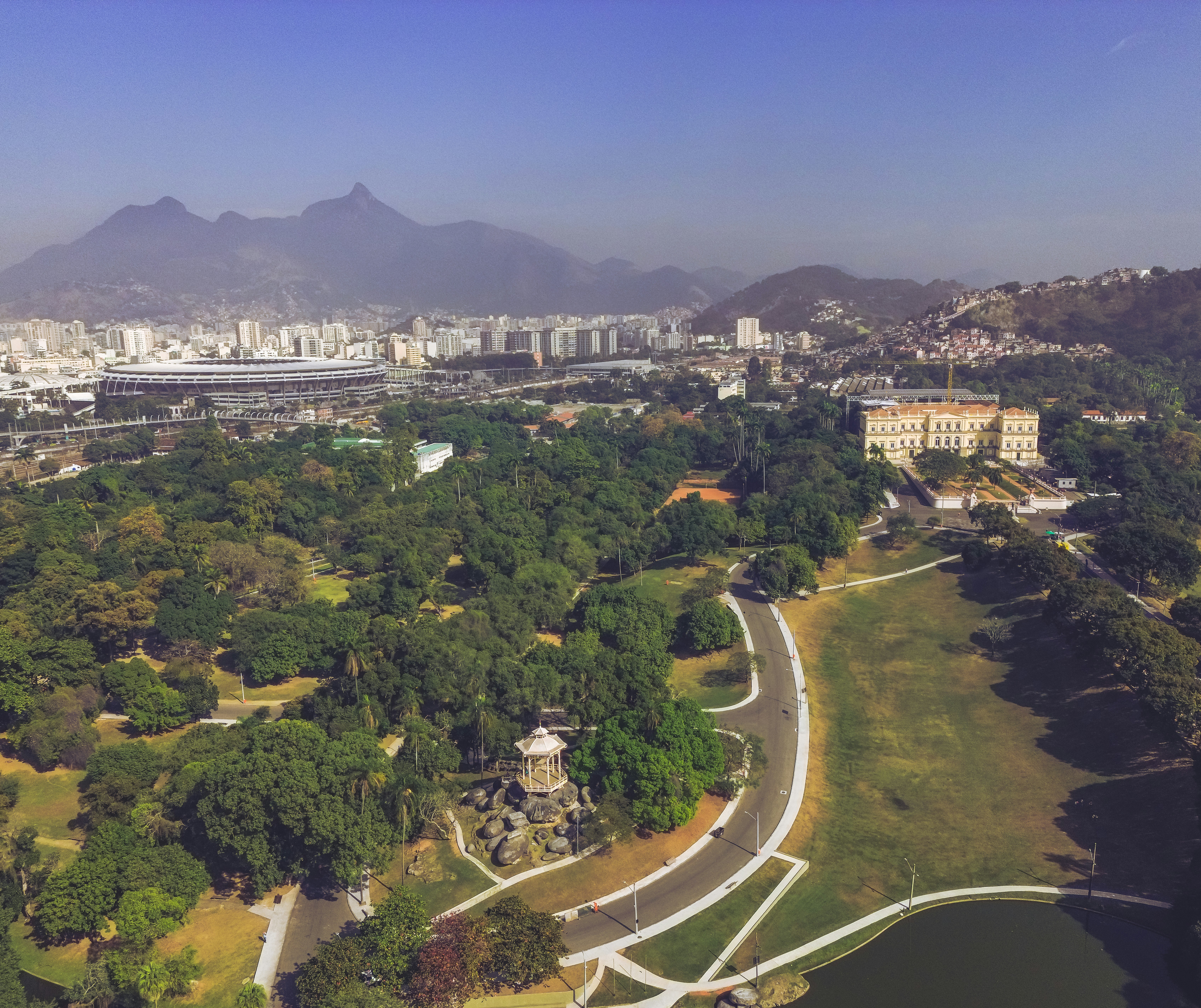 an aerial view of a park with a city in the background