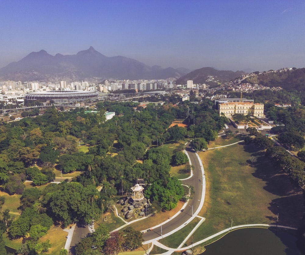 an aerial view of a park with a city in the background