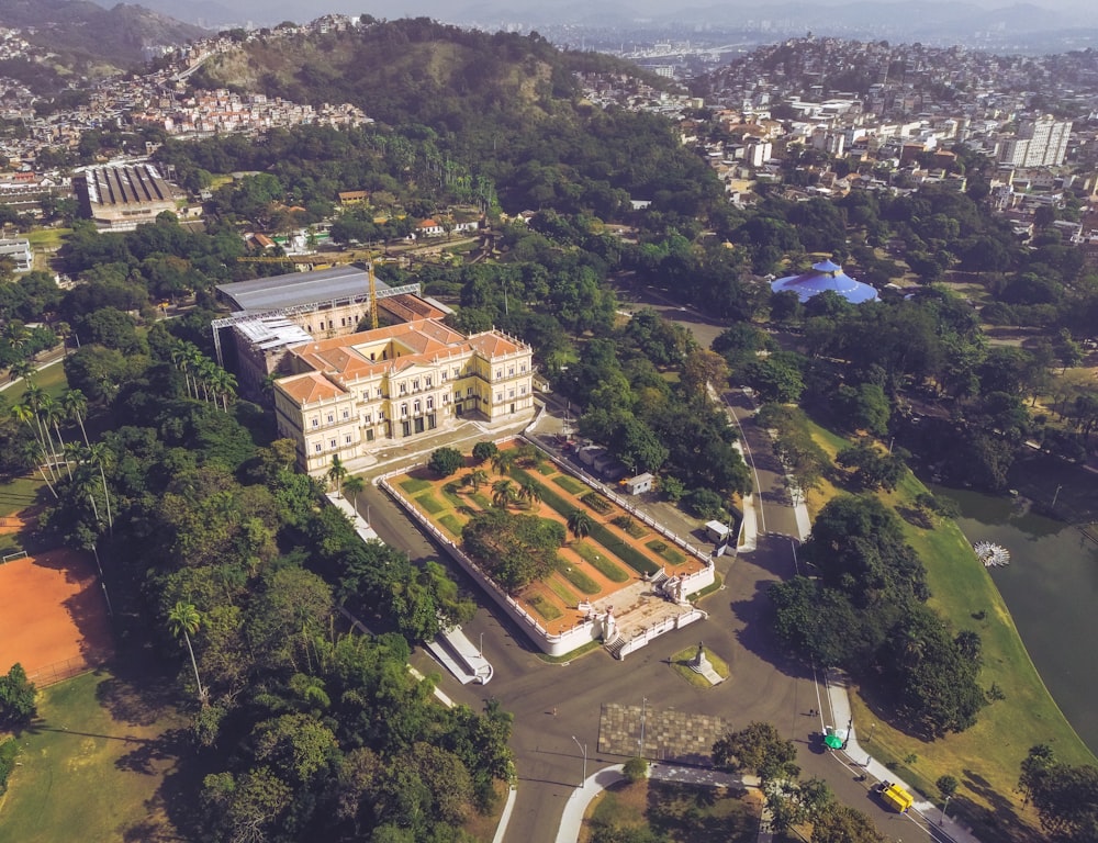 an aerial view of a large building surrounded by trees