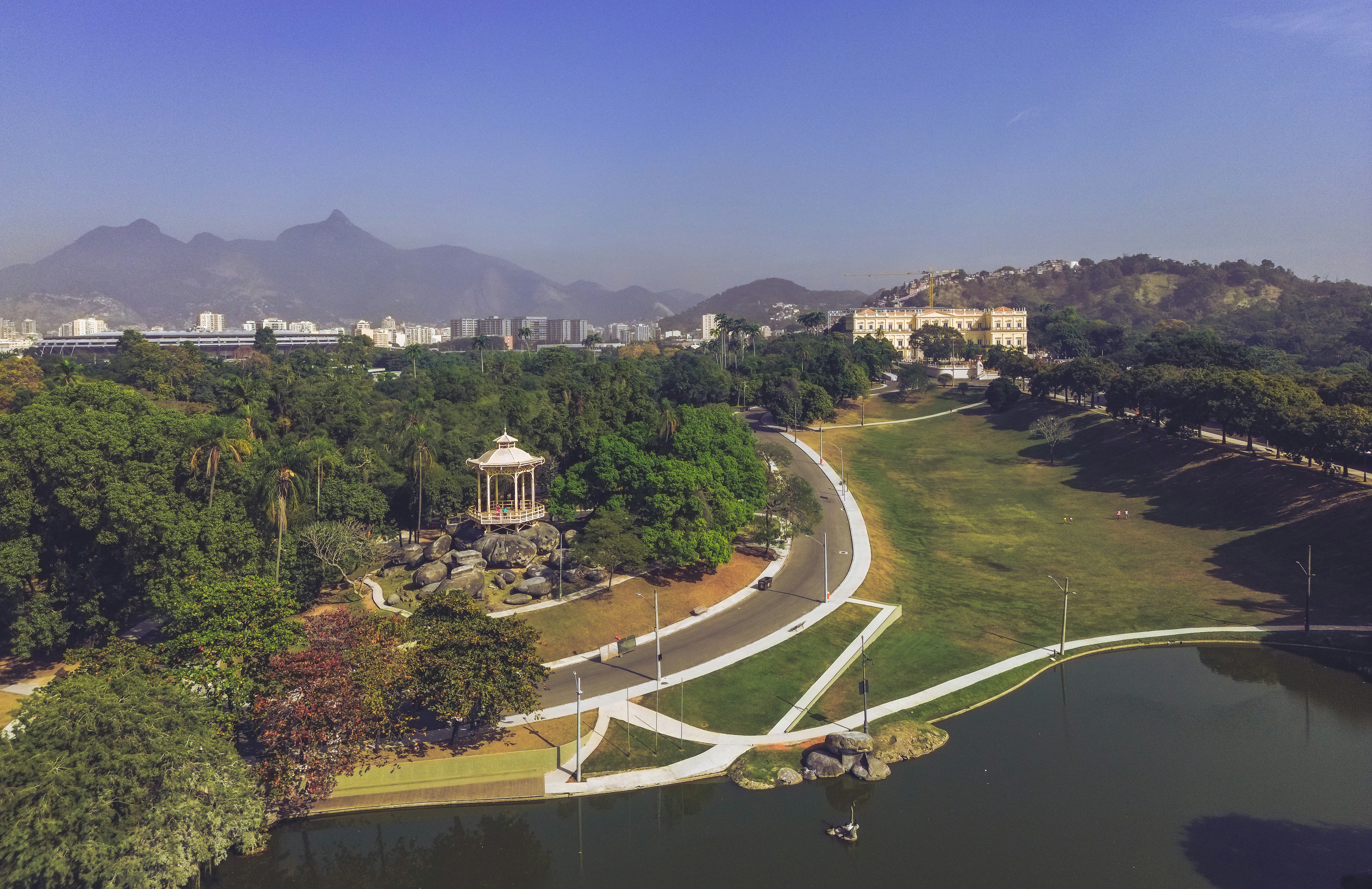 an aerial view of a park with mountains in the background
