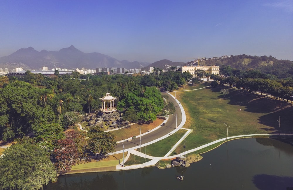 an aerial view of a park with mountains in the background