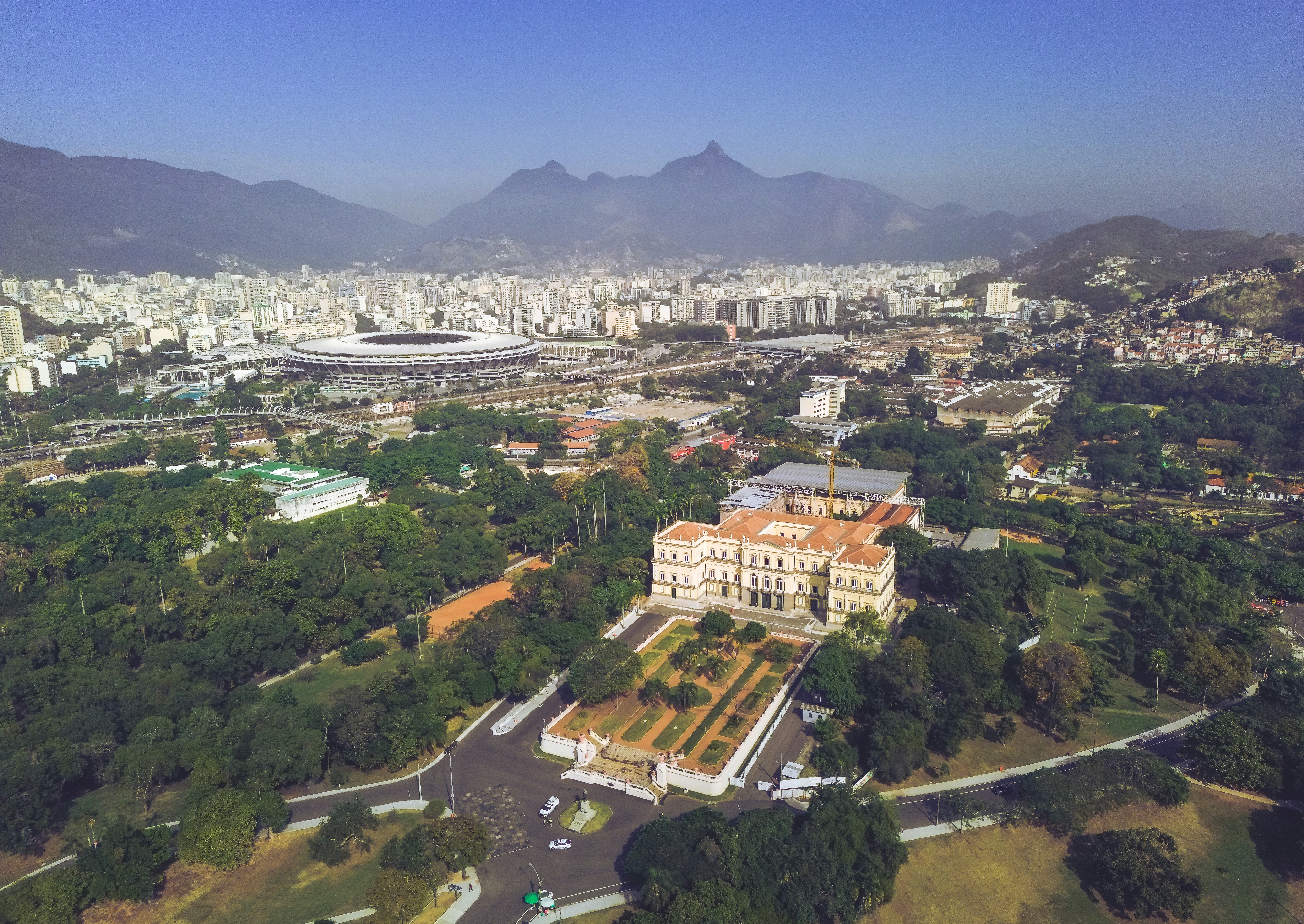 an aerial view of a city with mountains in the background