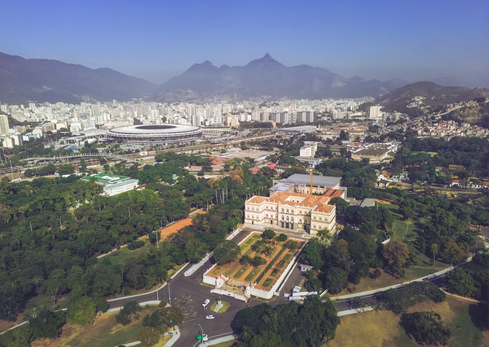 an aerial view of a city with mountains in the background